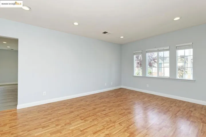 Empty room featuring light wood-style floors and recessed lighting