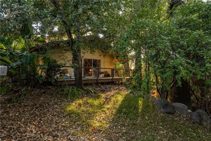 The main house features a deck overlooking the creek