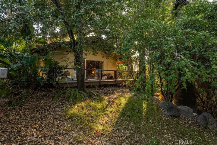 The main house features a deck overlooking the creek