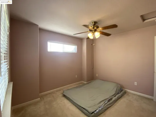 Big second Bedroom featuring a ceiling fan, carpet floors, and attic access