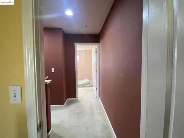 Hallway featuring baseboards and carpet floors