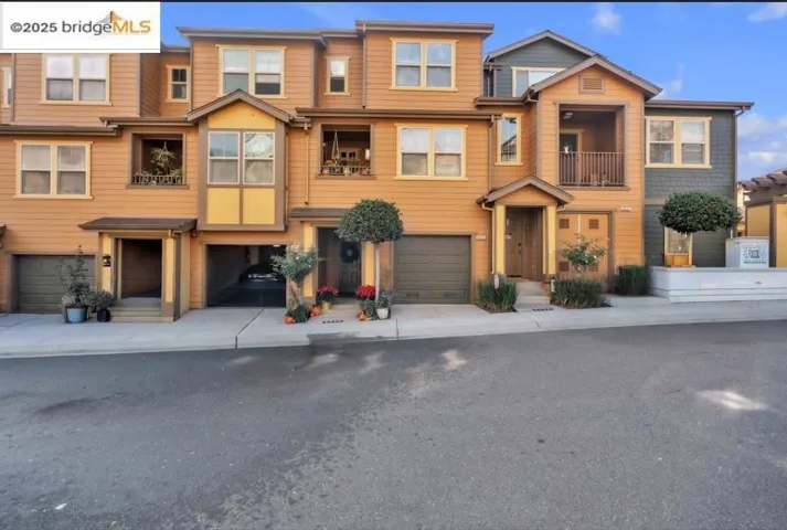View of front of home with a balcony, a residential view, and a garage