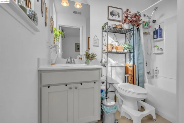 Bathroom with vanity and shower / tub combo