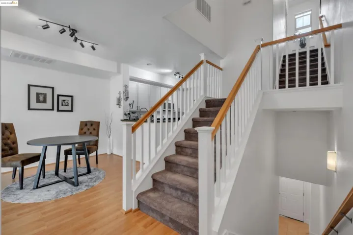 Staircase featuring wood finished floors