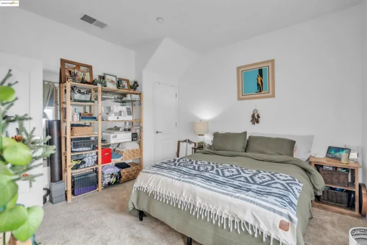 Bedroom featuring light colored carpet