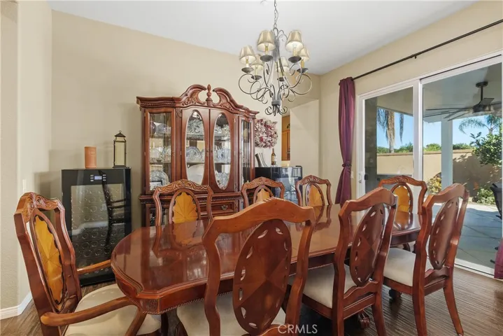 The dining room has a sliding door to the side covered patio. On this patio there is also an outdoor BBQ island.
