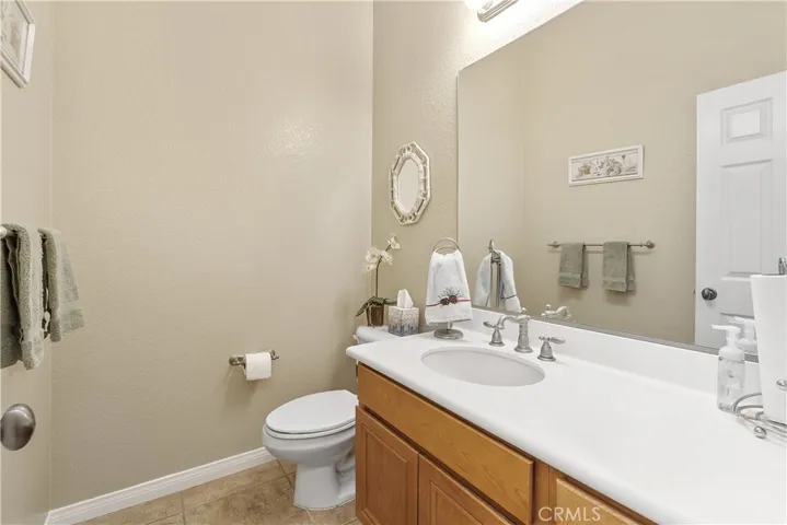 The guest 1/2 bath is off of the entry hallway convenient to the living area of the home.