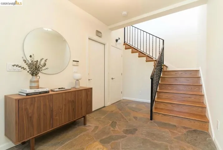 Foyer with stone flooring and a stairway
