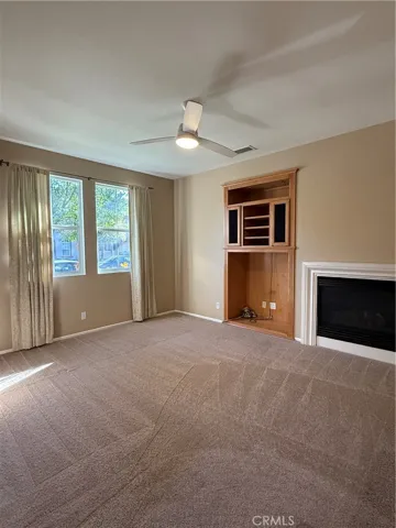 Formal living room is complimented by a gas fireplace.