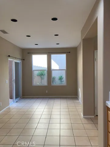 Formal dining opens up to the kitchen and out to the backyard.