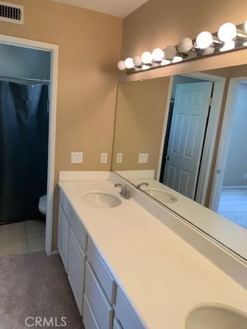 This bath opens to both secondary bedrooms and boasts dual vanities.