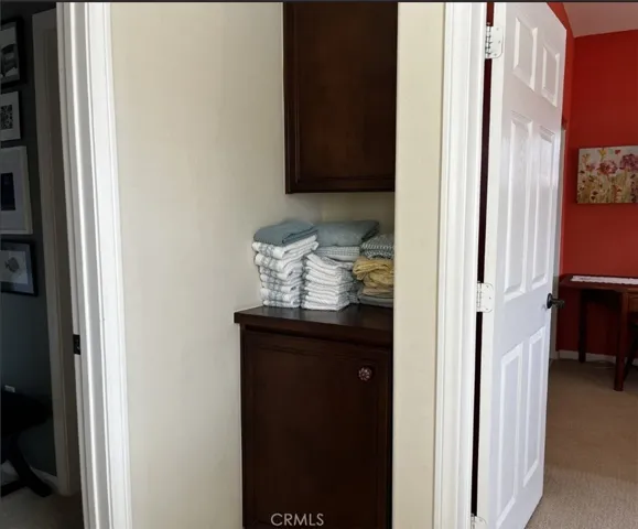Linen cabinet at top of stairs