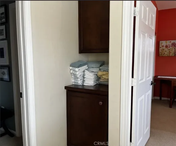 Linen cabinet at top of stairs
