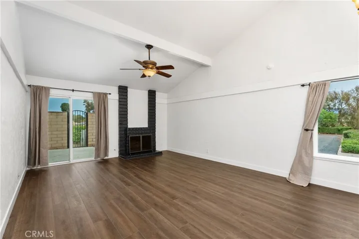Living room is adorned with a cozy fireplace with access to the private patio.