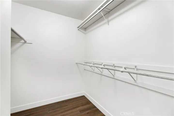 Walk in closet in primary bedroom.