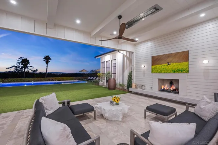 Outdoor living room with flush mount ceiling heaters, music, fire place and Summer Kitchen.