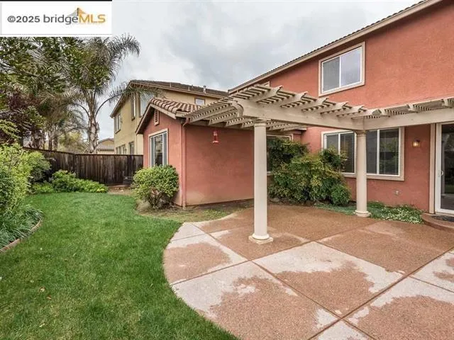 View of side of home with a patio, stucco siding, and a pergola