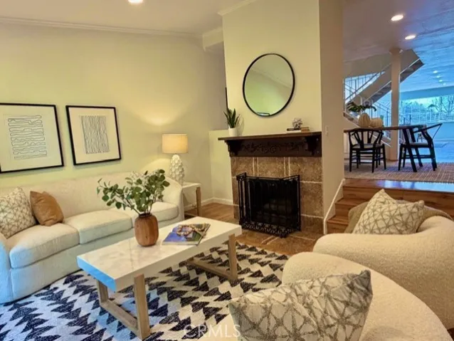 Step down to a cozy Living Room with fireplace.