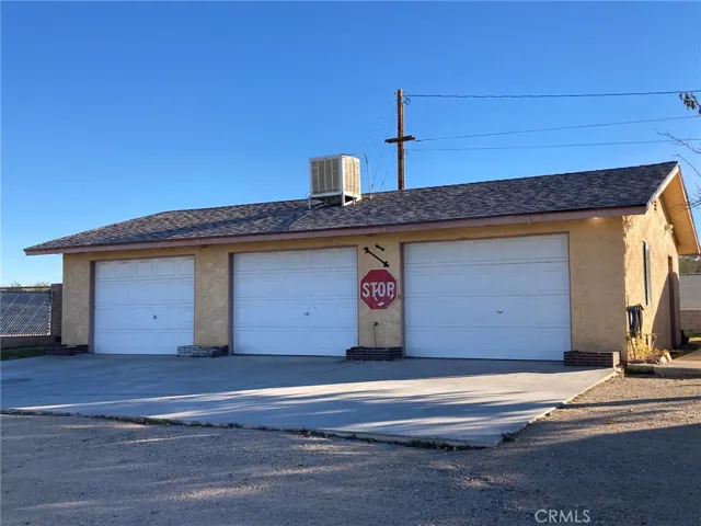  Triple garage with bathroom.   Pedestrian door to the right.