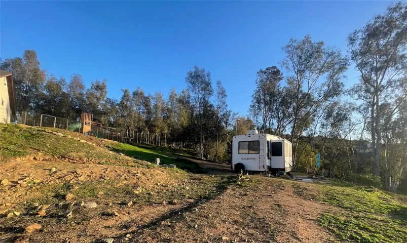 Graded RV pad with hookups and space for trailers, toys, and adventure.