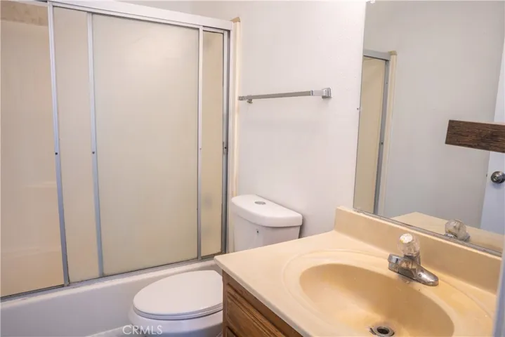 Bathroom is has a new toilet, mirror and flooring.  A new vanity and tub/shower would create a beautiful space!