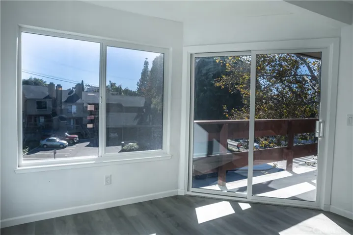 Living room features a balcony, accessible via a new Milgard slider, offers outdoor space to enjoy the legendary weather of the Central Coast.
