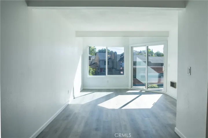 Living area is spacious, modern, and open to the dining area. New white rocker switches, outlets and cover plates complete the clean updates aesthetic.
