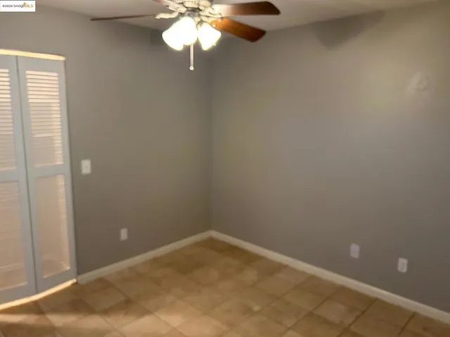 Spare room with baseboards and ceiling fan
