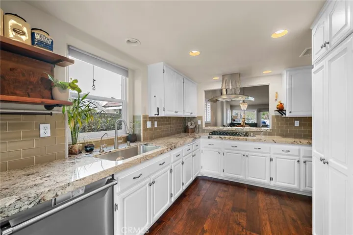 Open kitchen, stainless steel appliances.