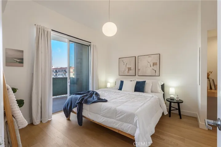 Bedroom with a peek of the balcony