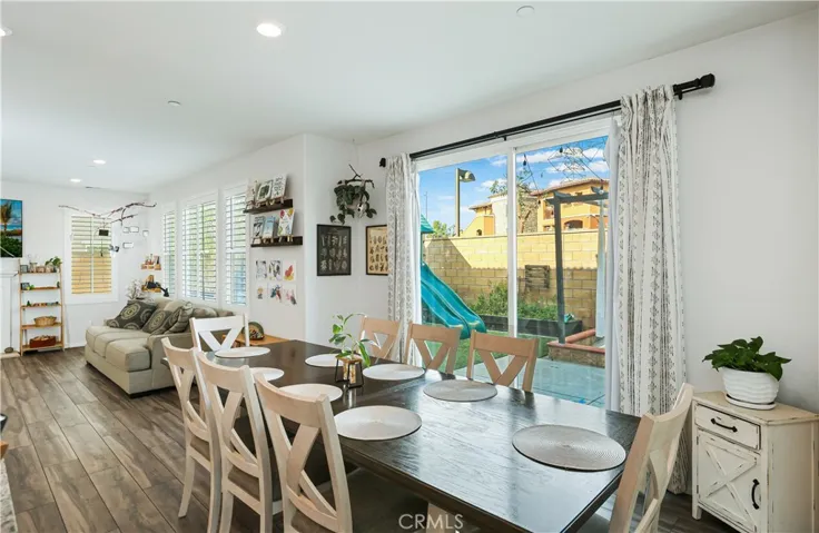 Large sliding glass door looks out to relaxing backyard