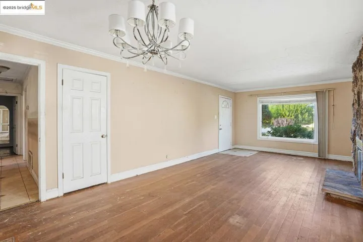 dining area  hardwood / wood-style flooring, a chandelier, and a fireplace