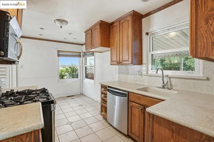 Kitchen featuring stainless steel appliances, brown cabinetry