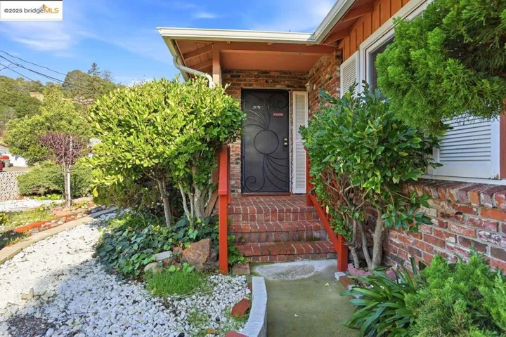 Doorway to property featuring brick siding and board and batten siding