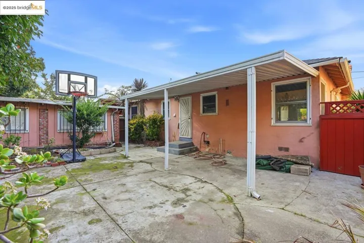 Rear of house with a patio area, stucco siding, and crawl space