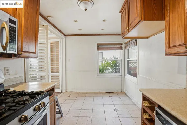 Kitchen featuring  appliances with stainless steel finishes, brown cabinetry