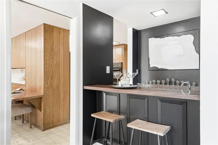 Bar area with seating, utility sink, and storage!