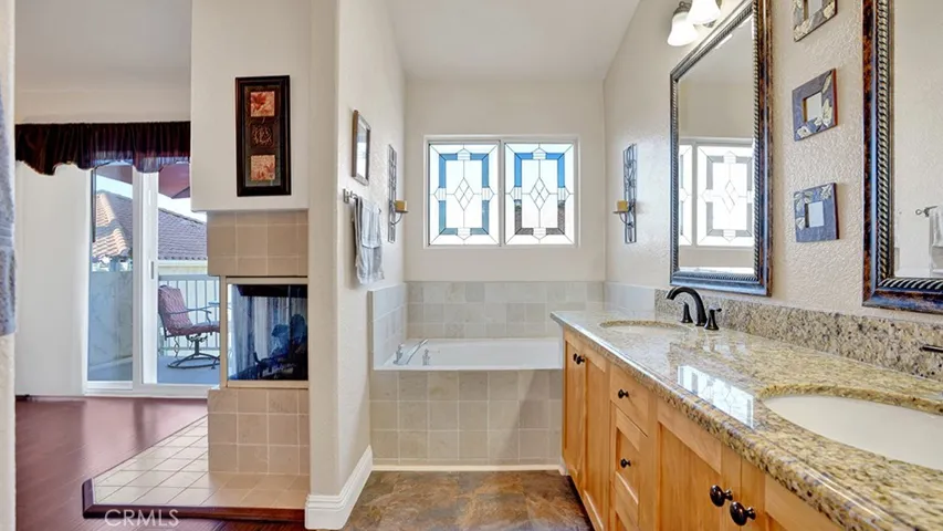The primary bathroom has a separate soaking tub, dual sinks and a walk in shower.
