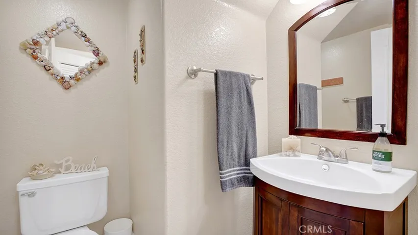 Downstairs is a half bath for guests. There is also a laundry closet directly across from the half bathroom.