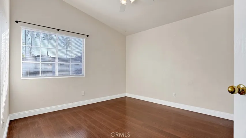 The second guest bedroom also has vaulted ceilings as well as a ceiling fan.
