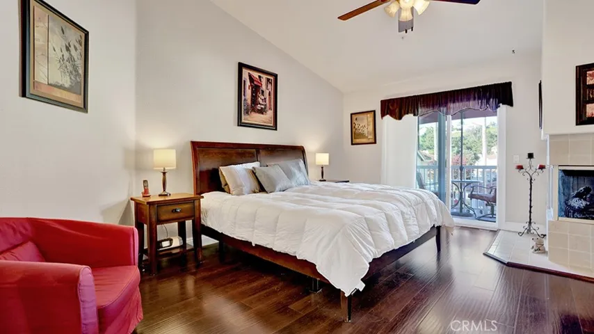 The primary bedroom has vaulted ceilings as well as a private balcony.