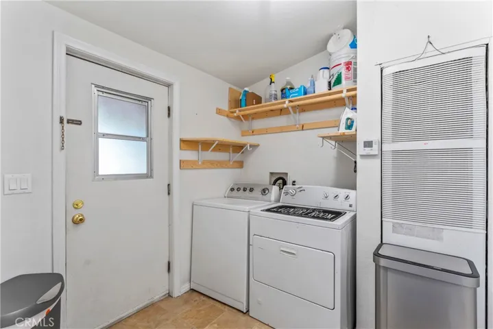 Laundry w/ exterior door, and access to kitchen & bath.