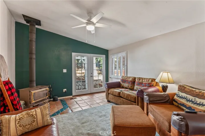Living Room 2 with wood burning stove, and French doors to back yard