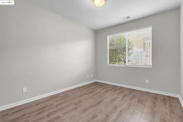 Unfurnished room featuring light wood-style floors and baseboards