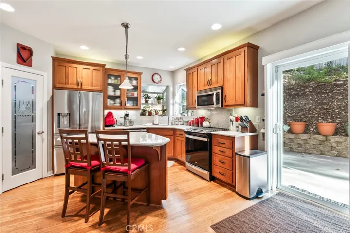 Spacious kitchen with abundant cabinetry, pantry, and a center island.