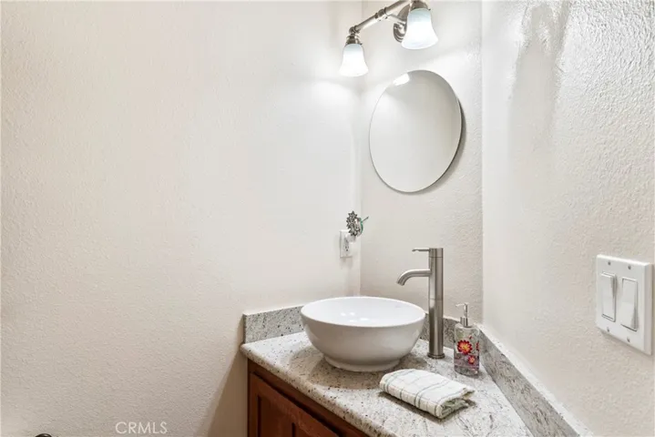 Half bathroom next to kitchen.
