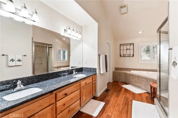The ensuite bathroom offers a large spa tub, a separate shower, privacy door for toilet and double sinks.