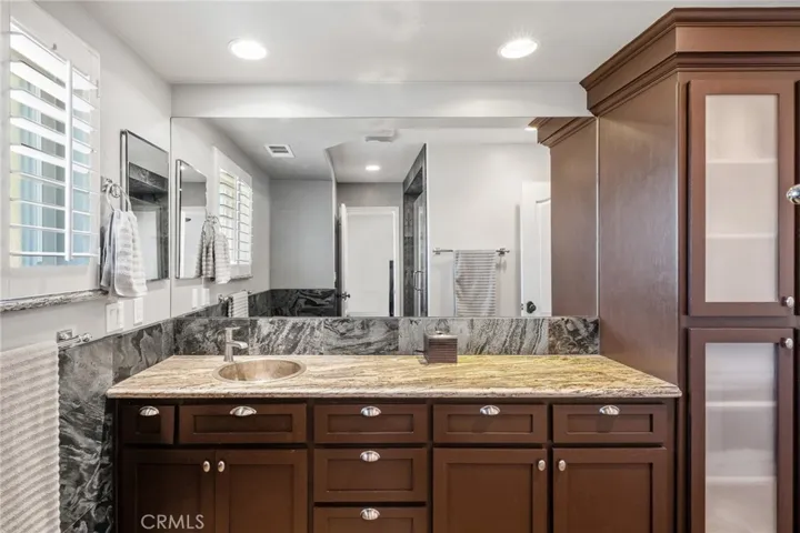 Custom reeded glass cabinetry and dual sinks