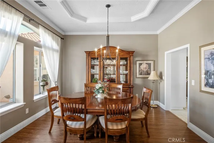 Entertain in style in this elegant formal dining room flooded with natural light from large picture windows offering stunning mountain views