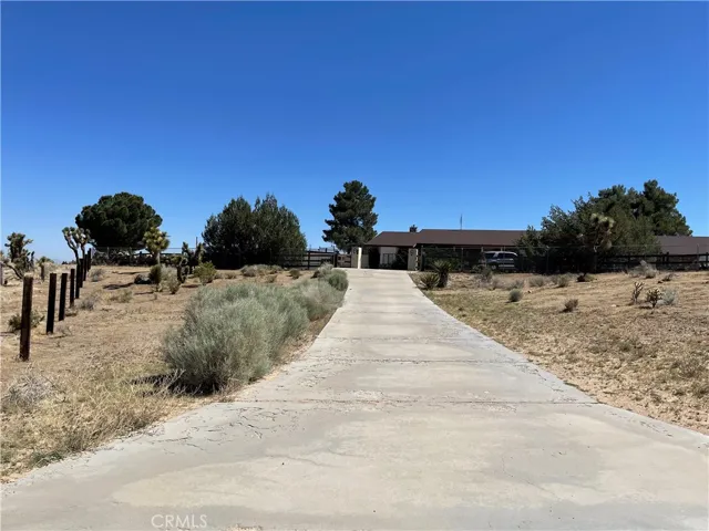 Front concrete driveway leading to main gate